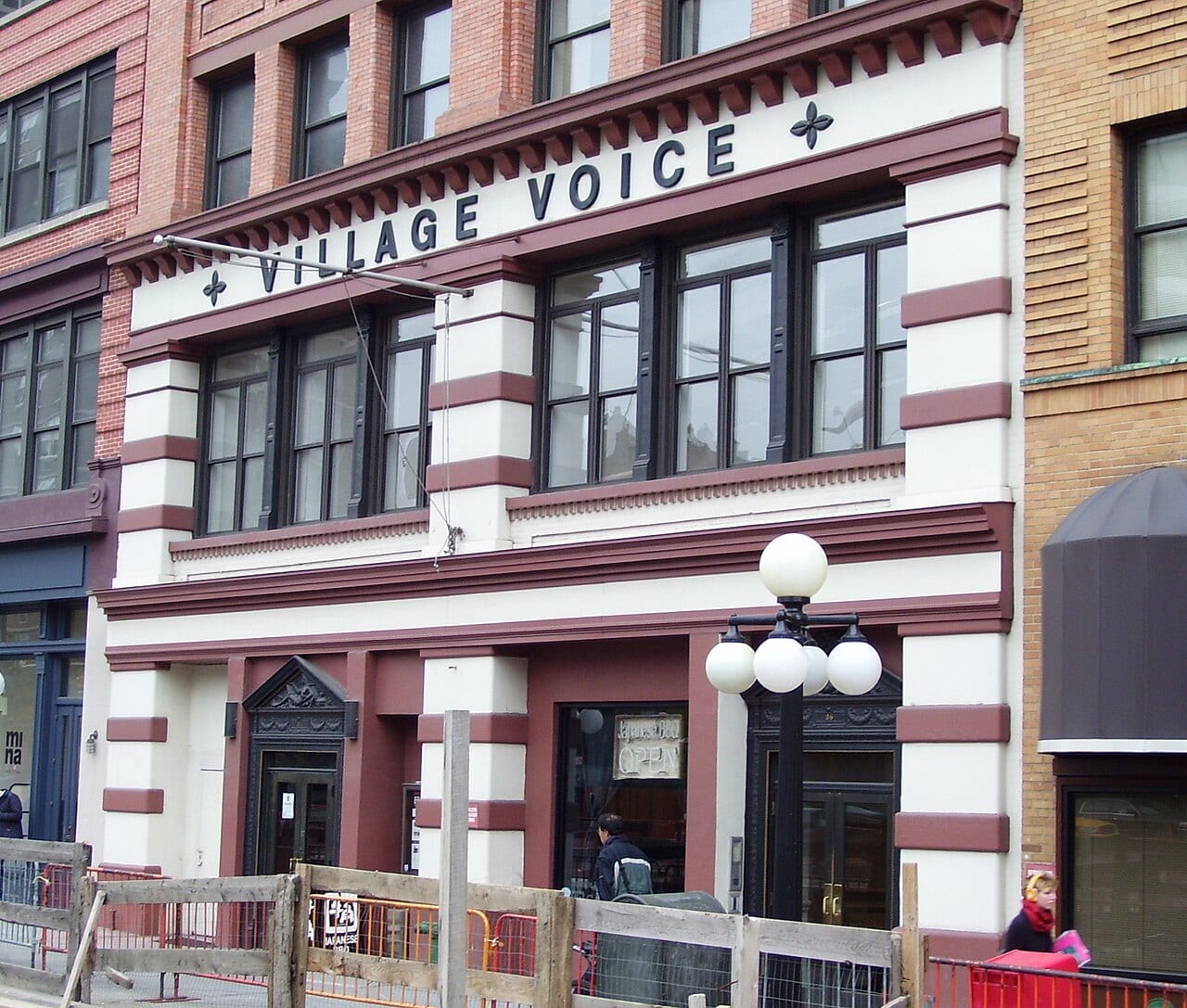 The front of 36 Cooper Square in Manhattan, with the Village Voice's name across the top of the building