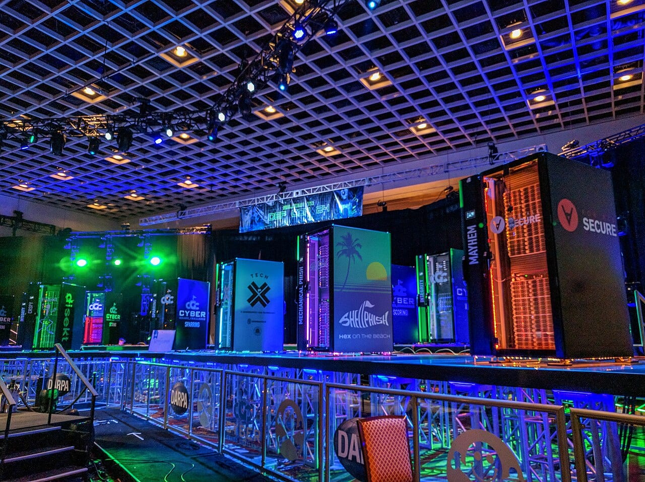 Competitors at a capture-the-flag hacking contest at DEF CON, the kind of test AISI ran on Claude Mythos 5