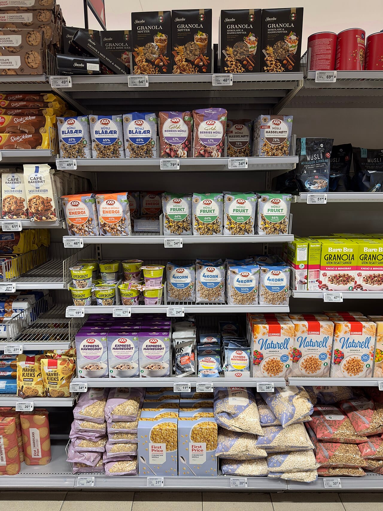 Grocery store shelves stocked with cereal, oatmeal and muesli boxes in a Norwegian supermarket aisle
