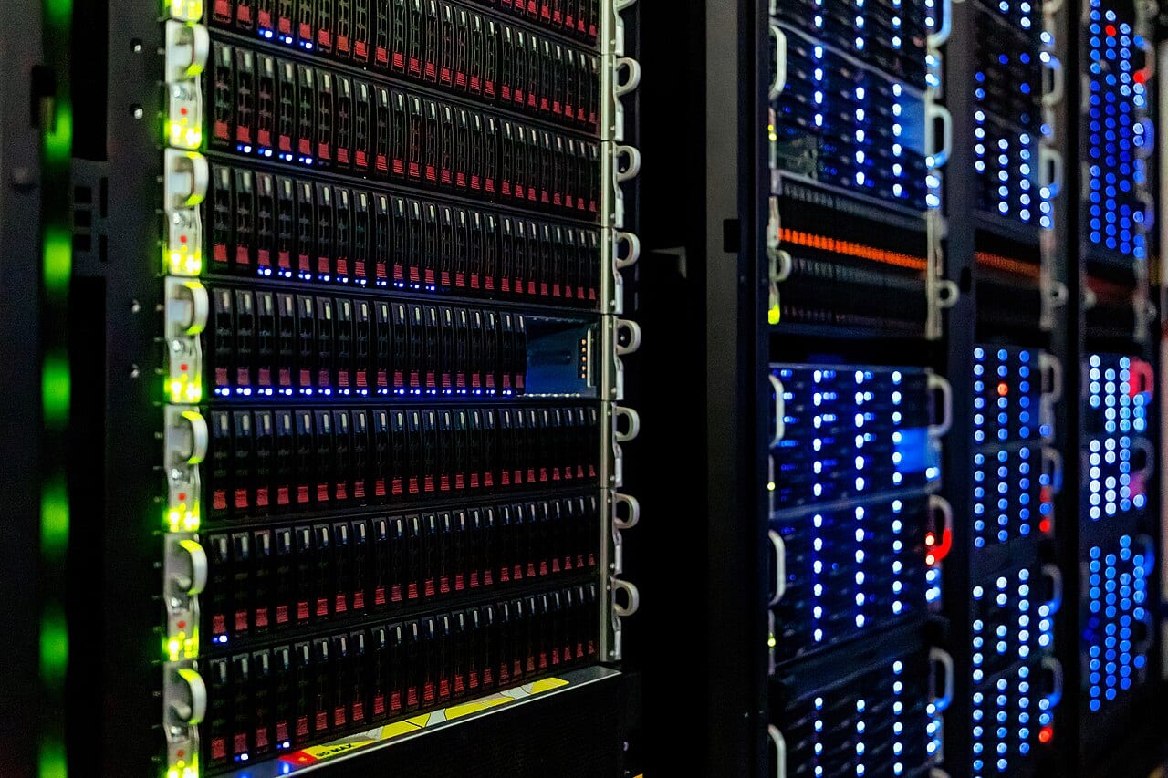 Server racks stand in rows inside a computer room