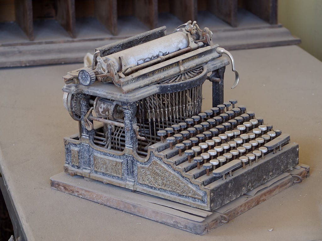 A dusty antique Smith Premier typewriter sits abandoned in the ghost town of Bodie, California