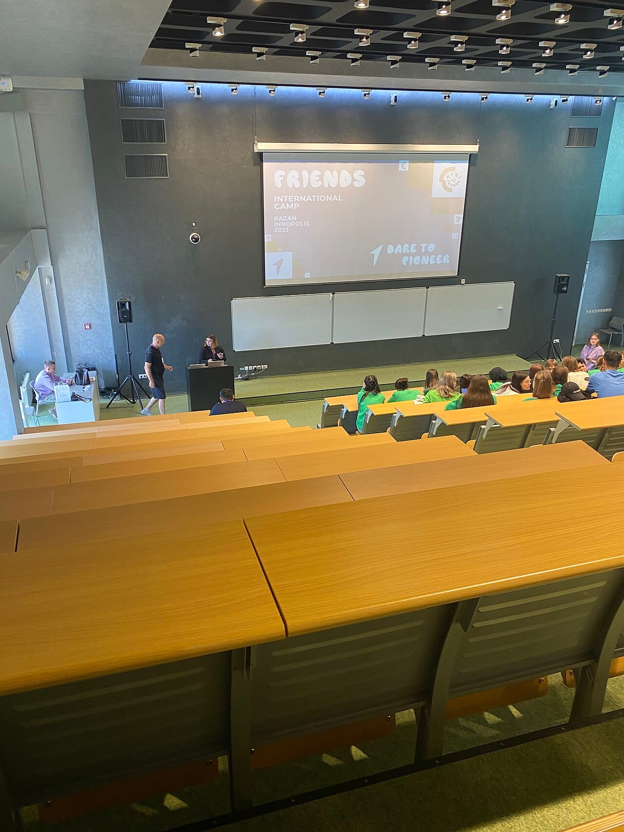 Students gather in a university lecture hall