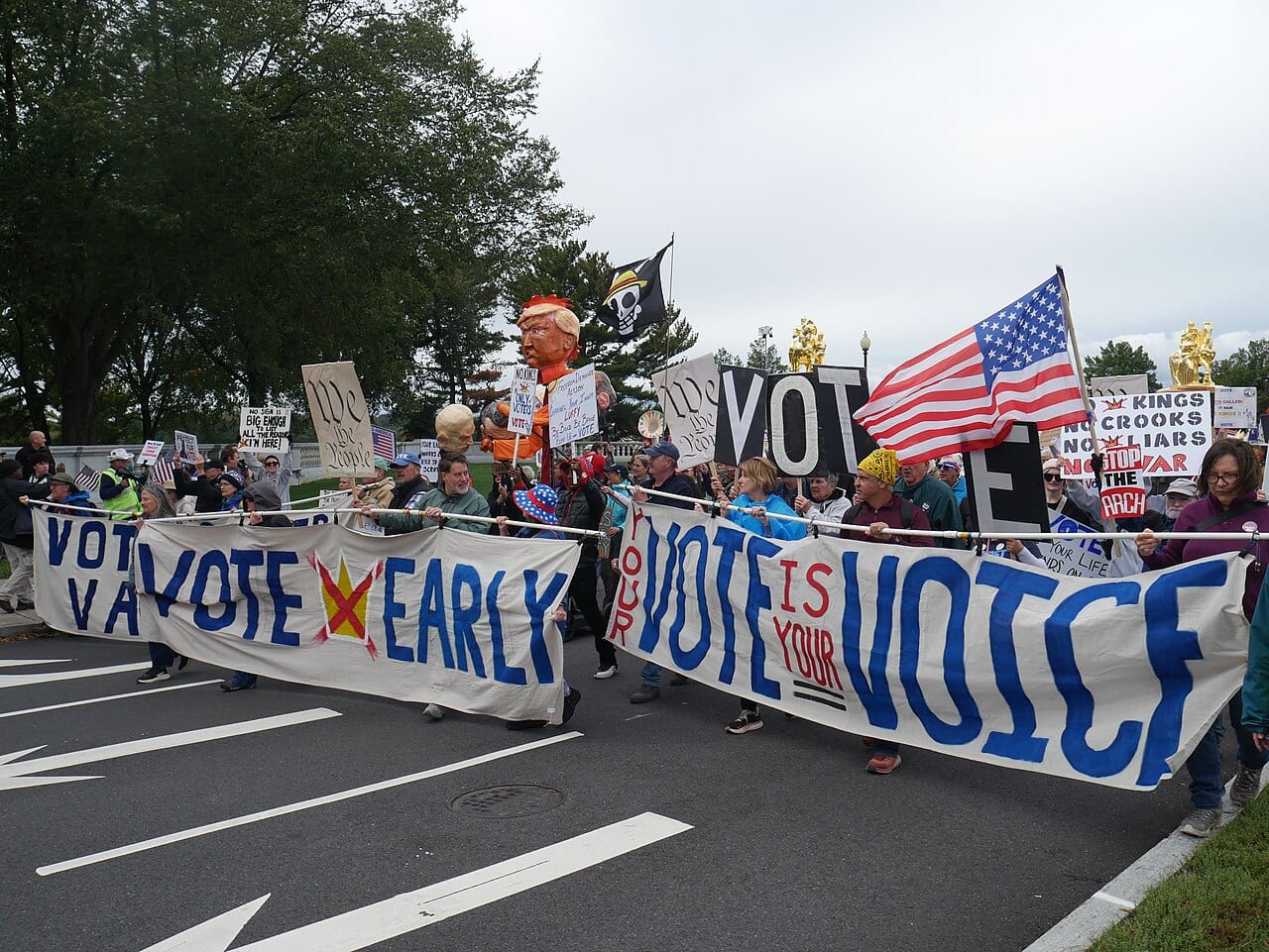 Demonstrators carry signs through downtown Washington, D.C., during nationwide protests on Oct. 17, 2026