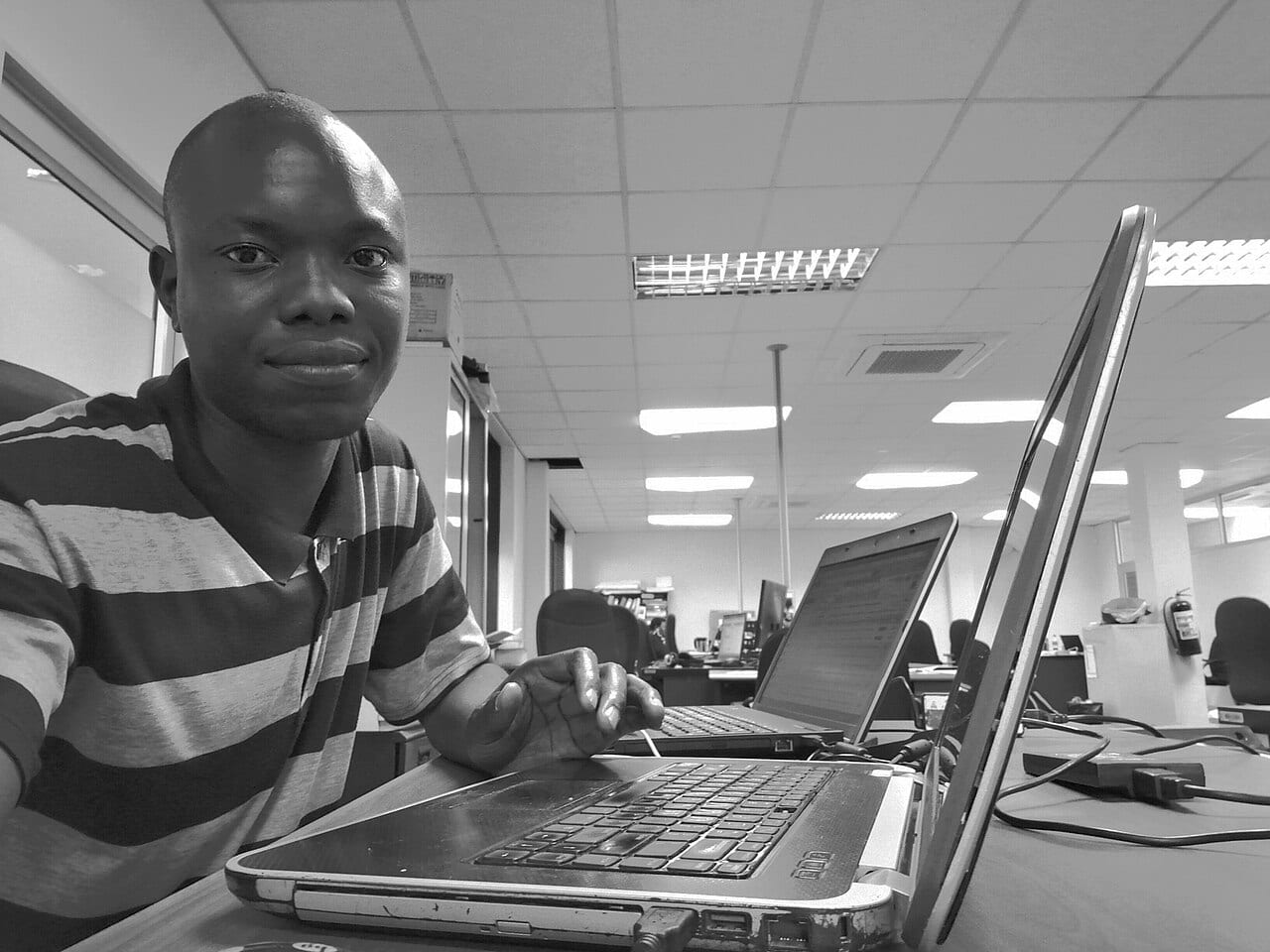 A software developer works at a laptop