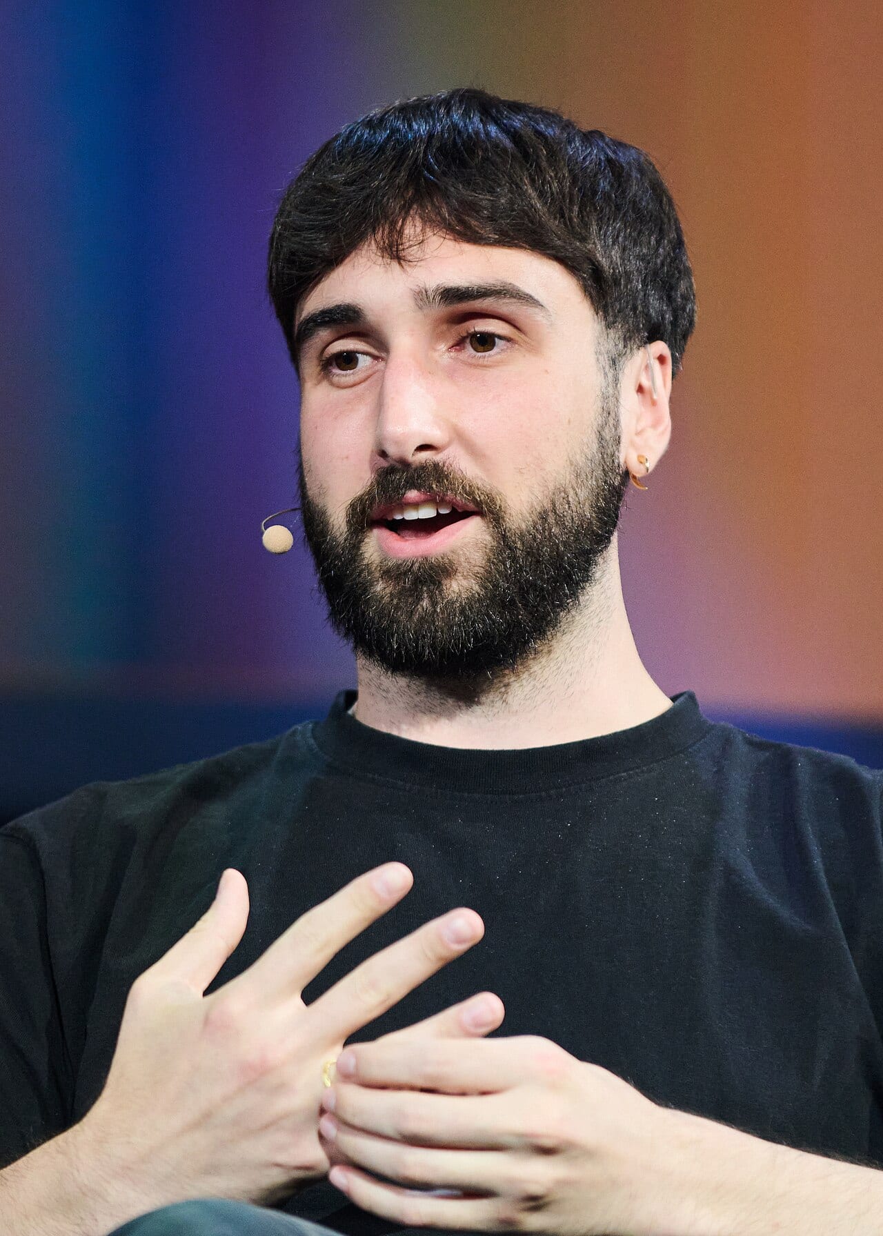 Aidan Gomez speaking on a panel at a technology conference