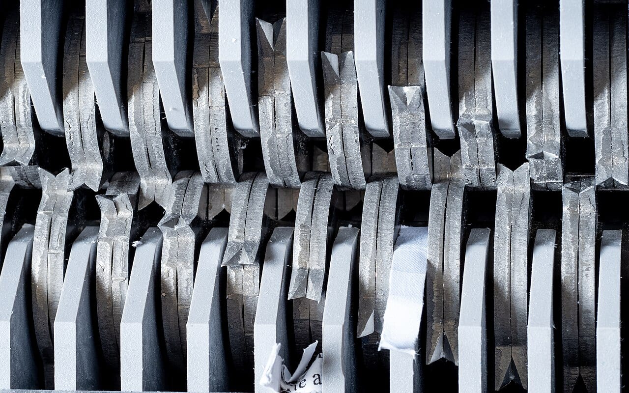 The feed blades inside an open paper shredder
