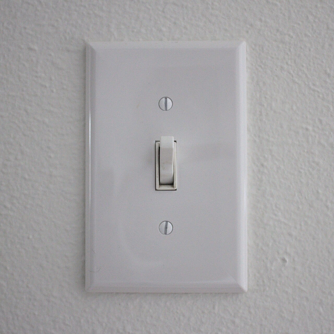 A toggle light switch mounted on a wall
