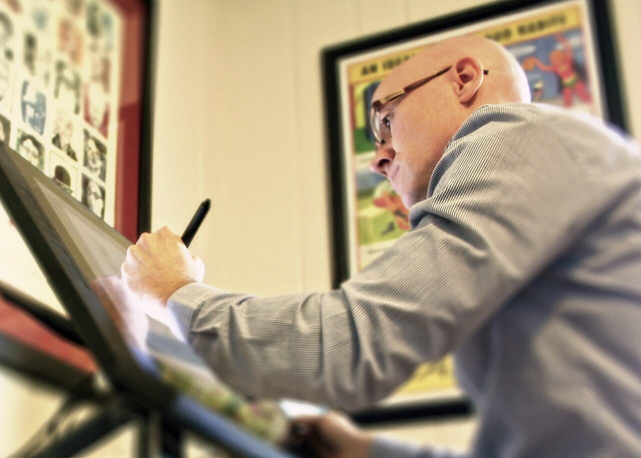 Illustrator Kyle T. Webster draws on a digital tablet in his home studio