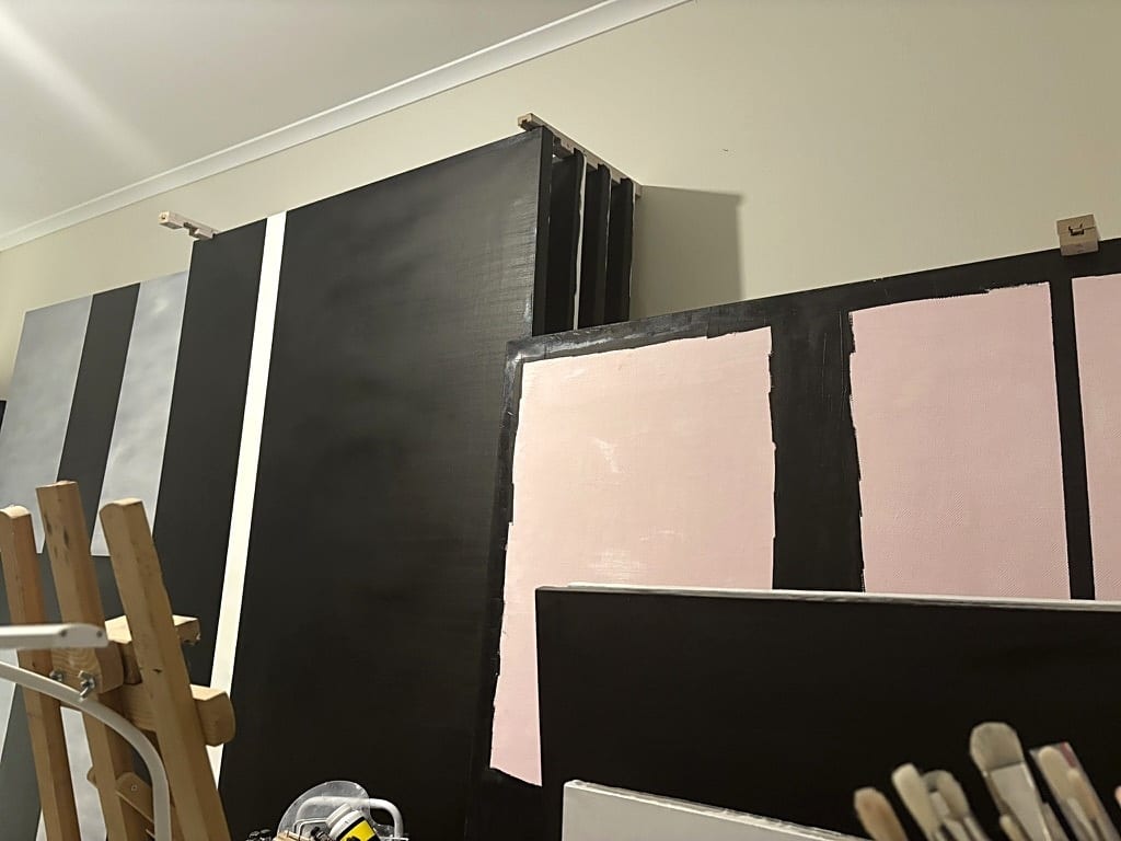 An easel holding a painting in progress inside a working artist's studio