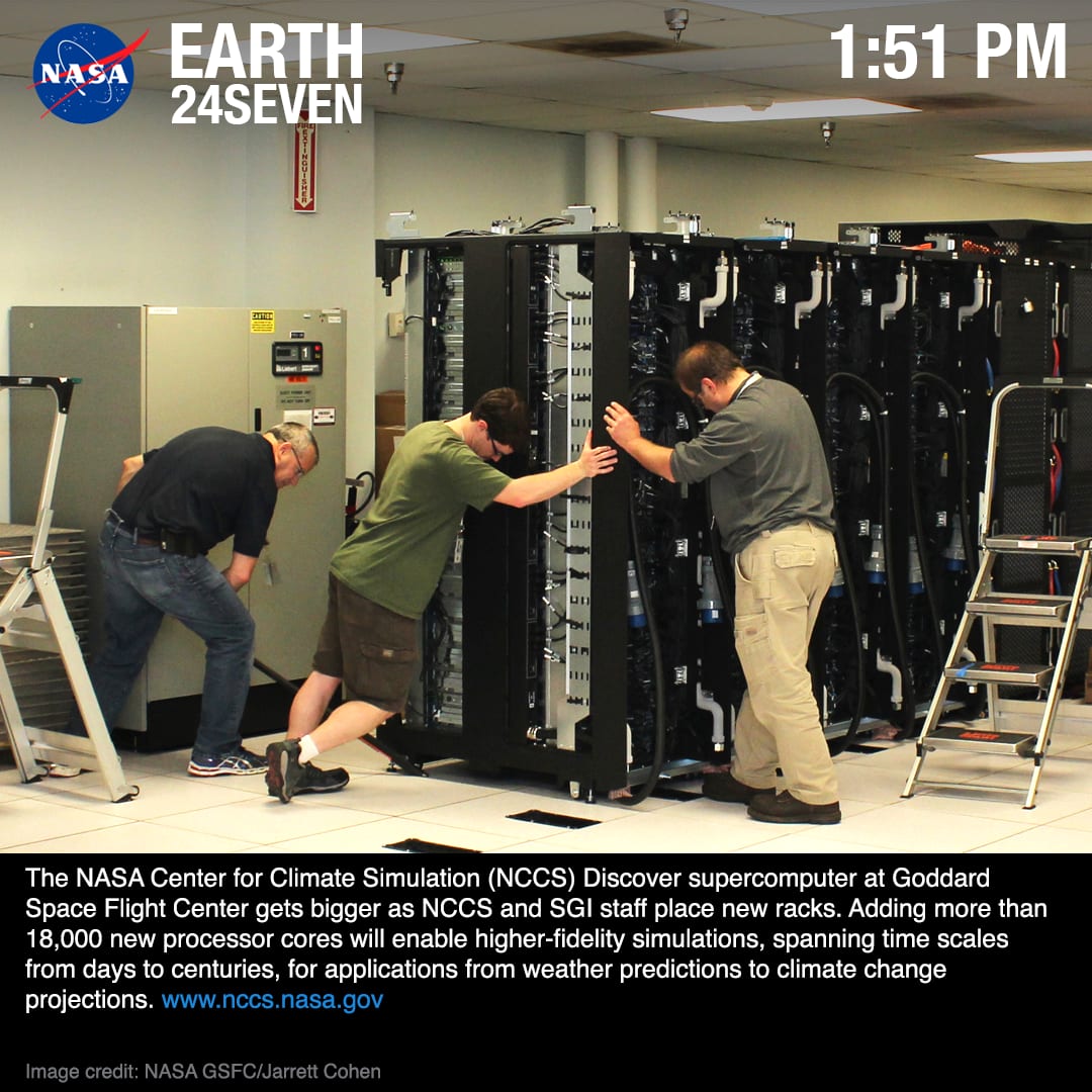 Staff install new processor racks at a NASA supercomputer center