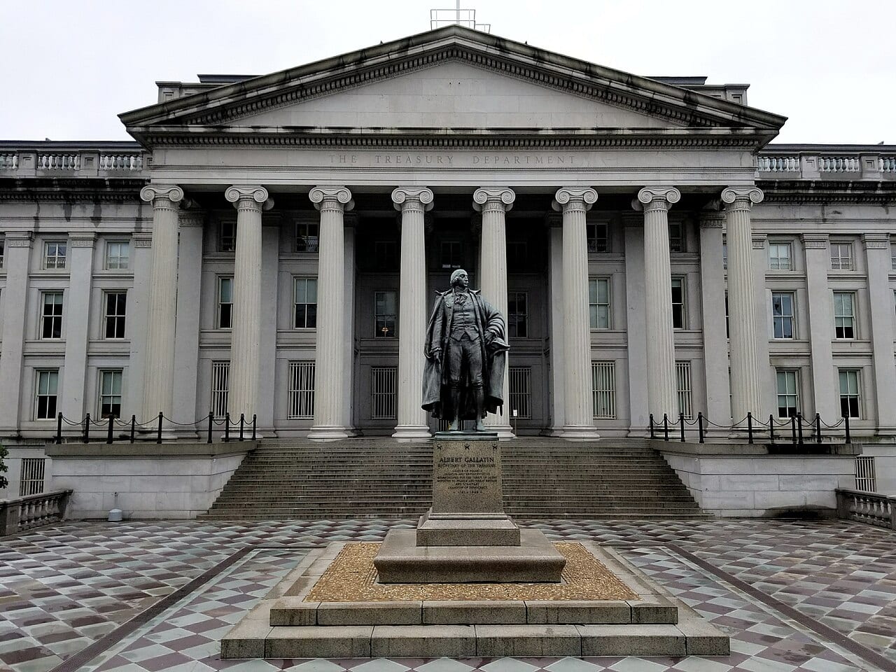 The U.S. Treasury Building in Washington, D.C., with the statue of Albert Gallatin in front of its columns