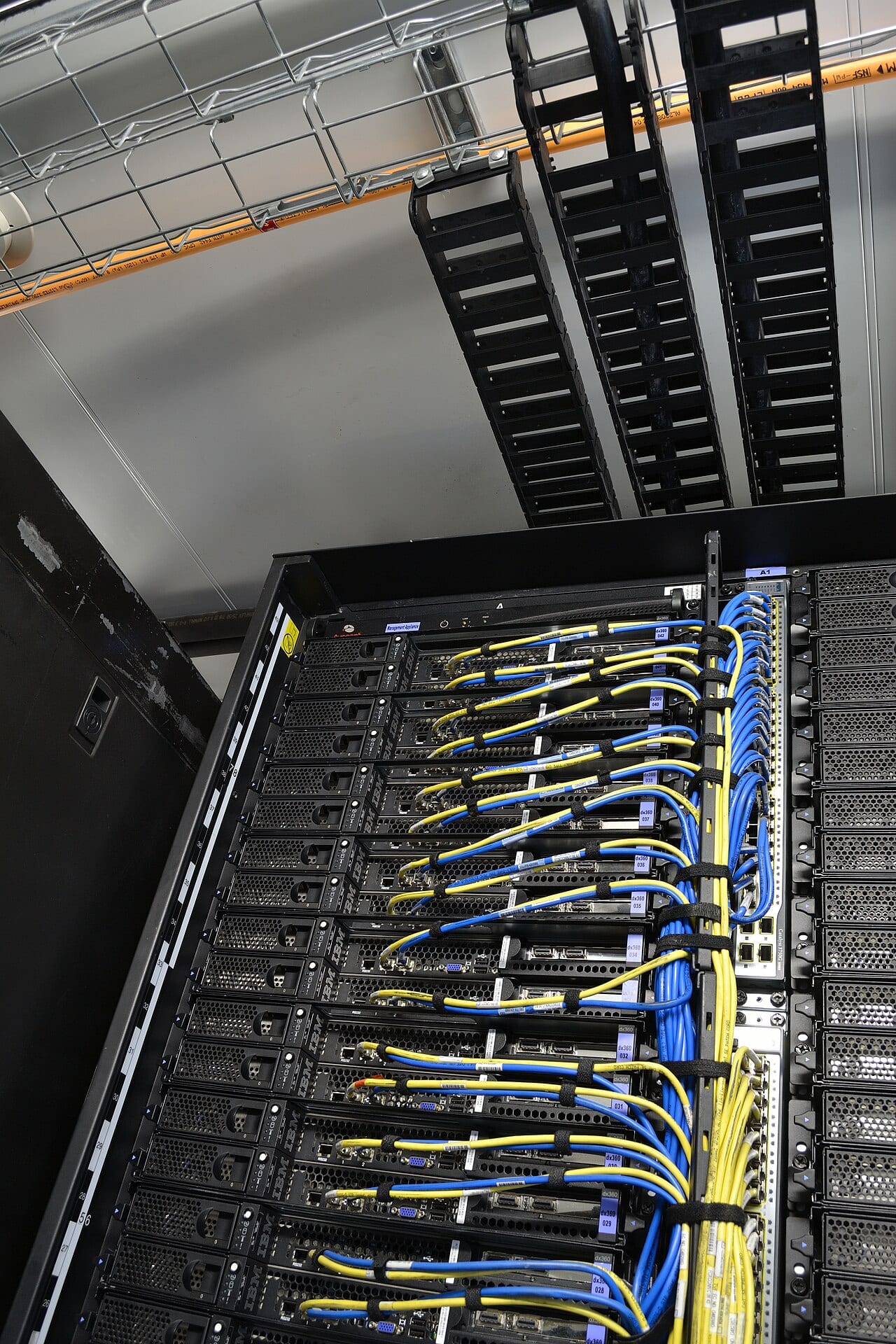 Power and network cables run into a server rack inside a modular data center container