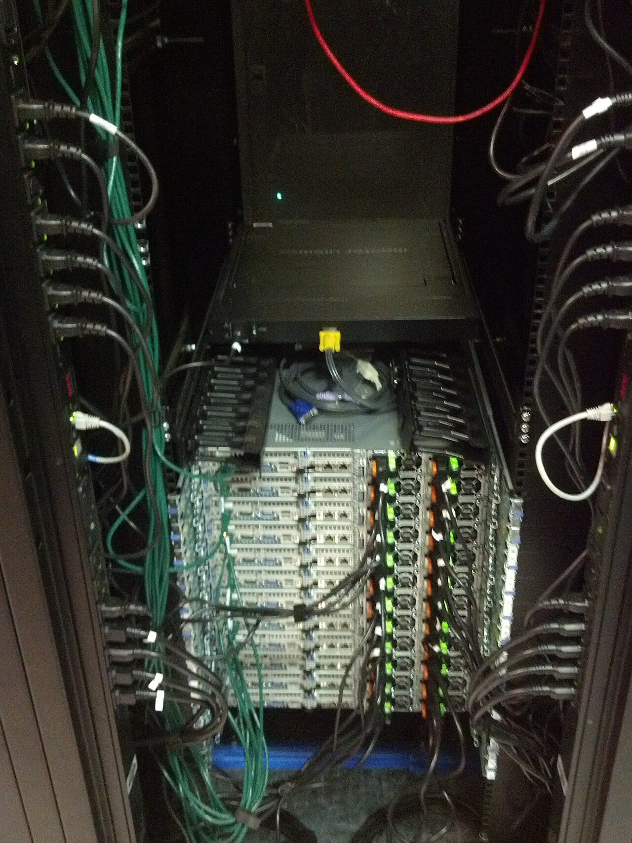 Server racks standing in rows inside a data center caching facility