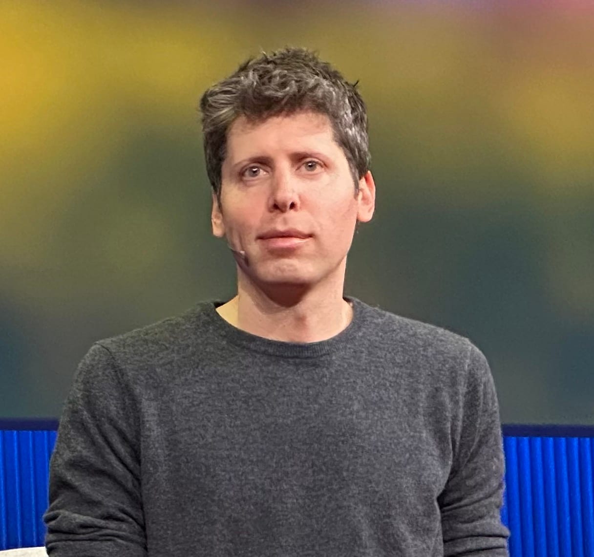 Sam Altman speaks on stage at a TED event