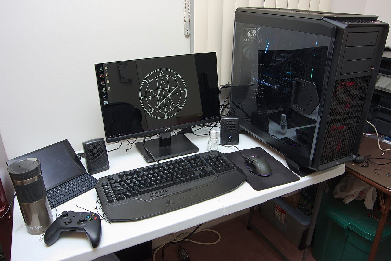 A finished gaming PC build with a glass side panel showing its internal graphics card