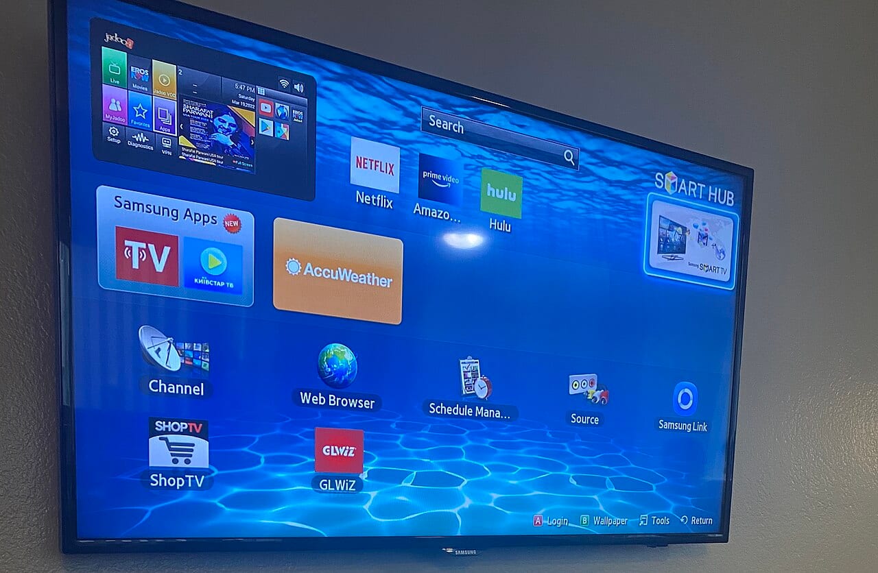 A Samsung Smart TV displays its own home screen interface
