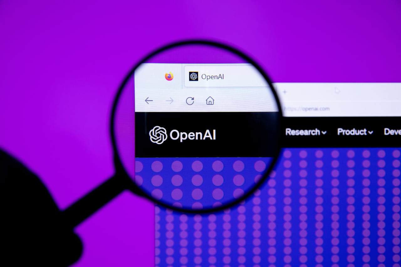 The OpenAI logo seen through a magnifying glass
