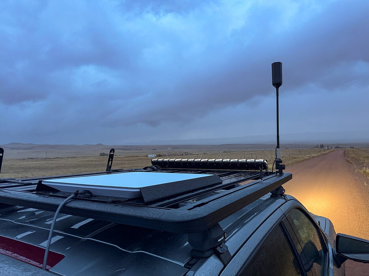 A flat-panel Starlink dish mounted on the roof of a truck