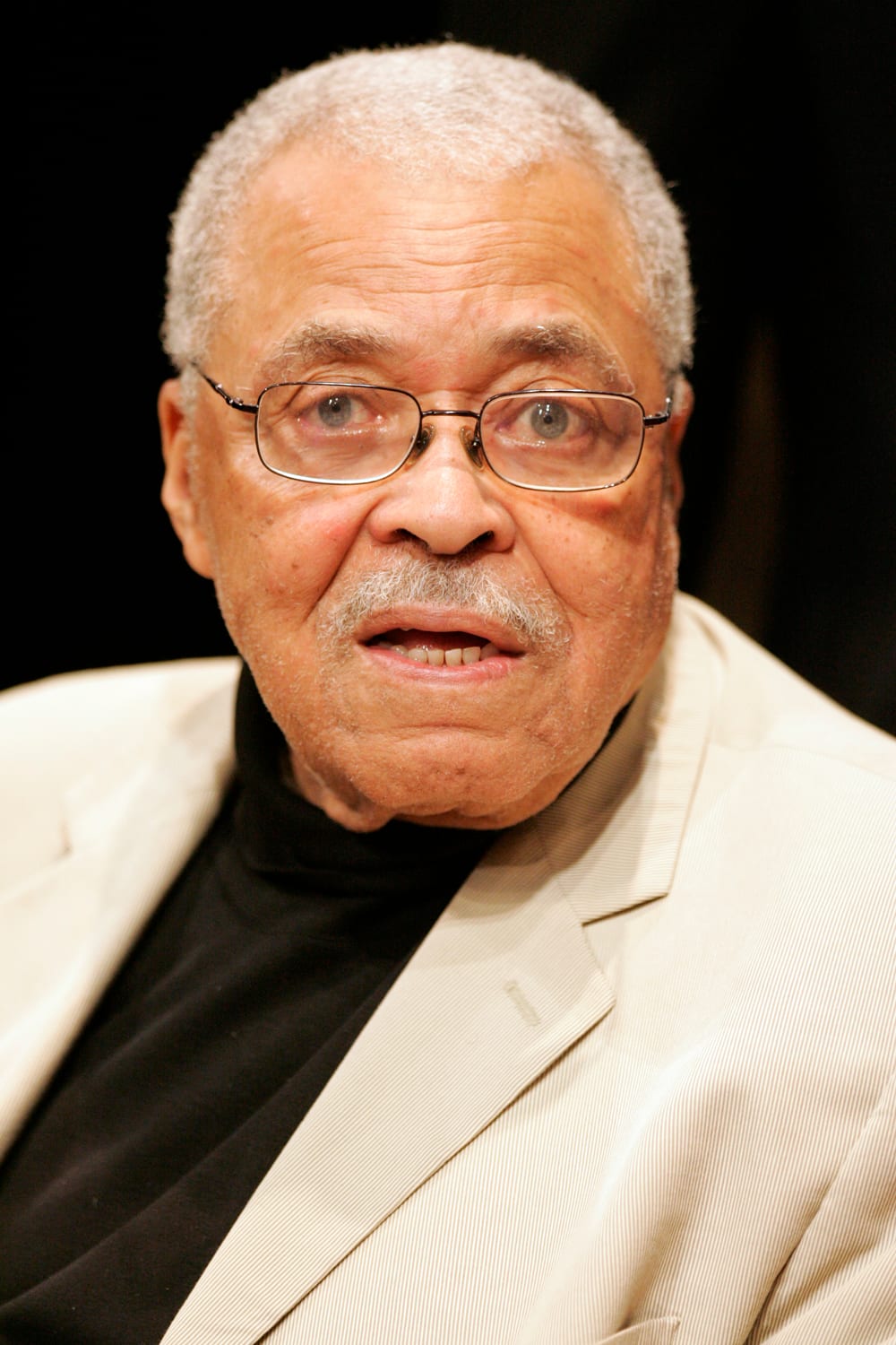 James Earl Jones smiling in a dark suit at a public event