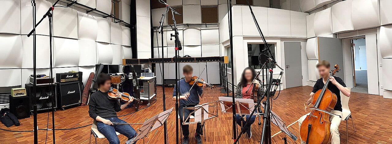 A string quartet records a session in a studio