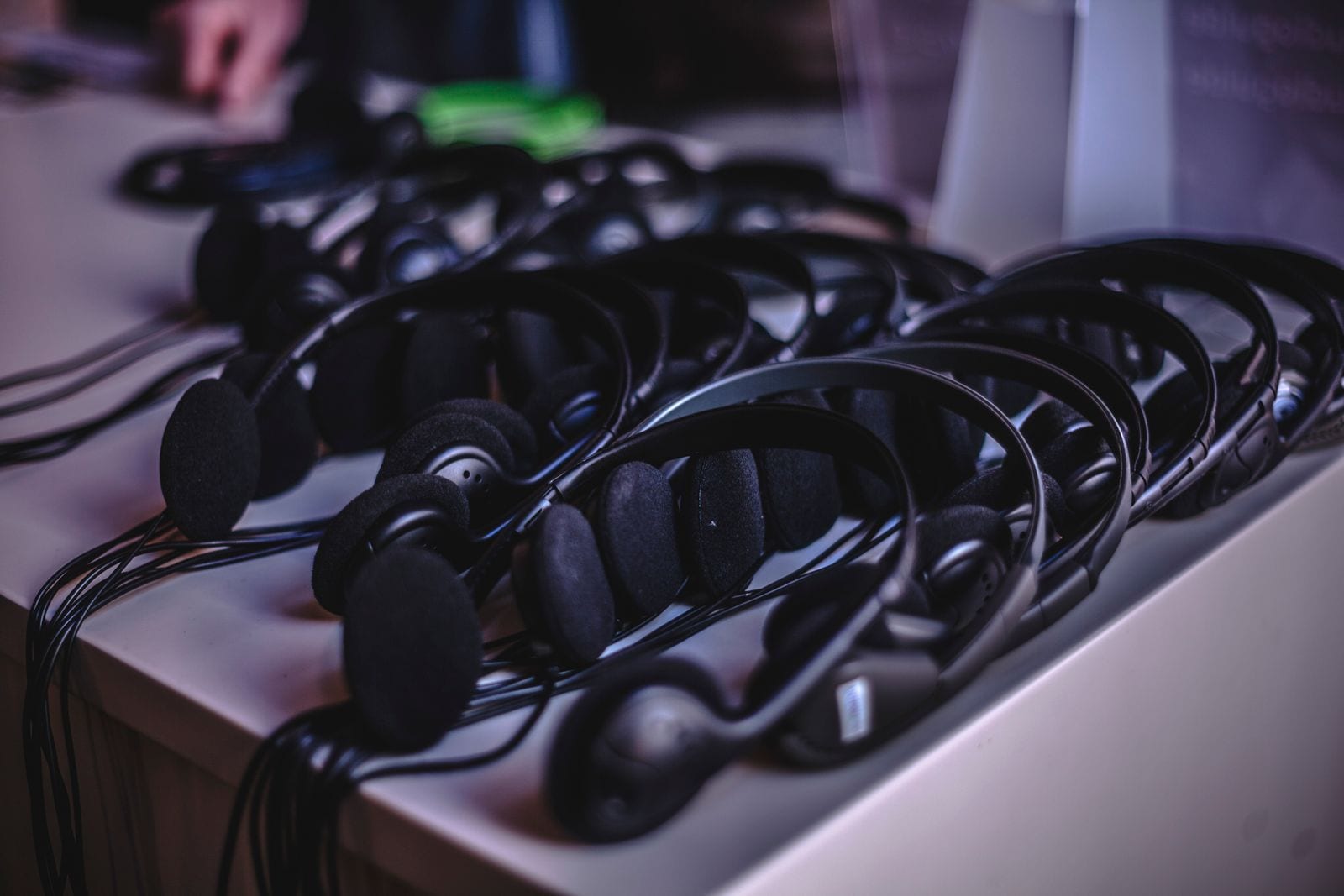 A row of interpreter headsets laid out with no one wearing them