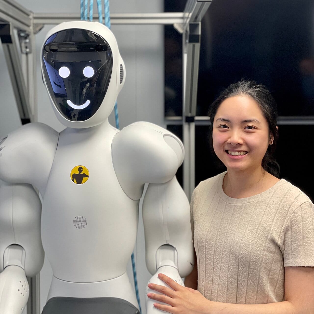 An engineer works alongside a humanoid collaborative robot
