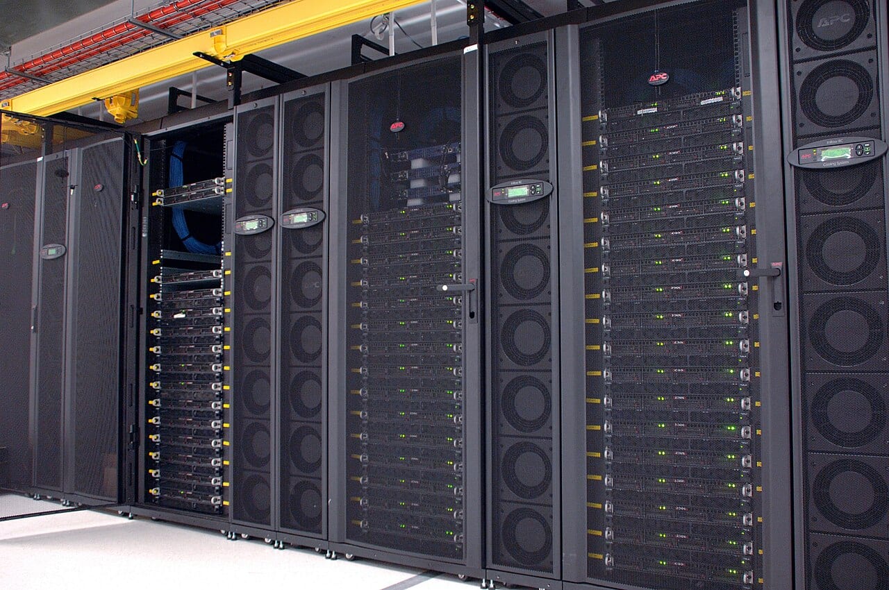 Rows of server racks holding a GPU cluster inside a data center