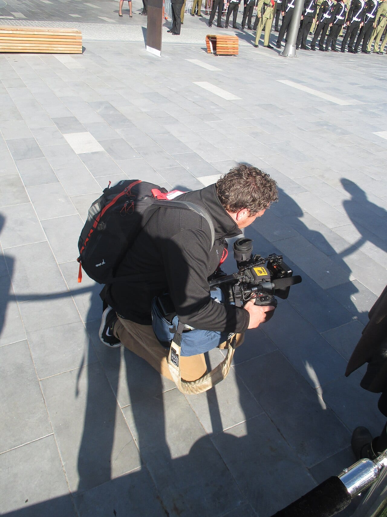 A camera operator records a public event, one of the crafts IATSE represents