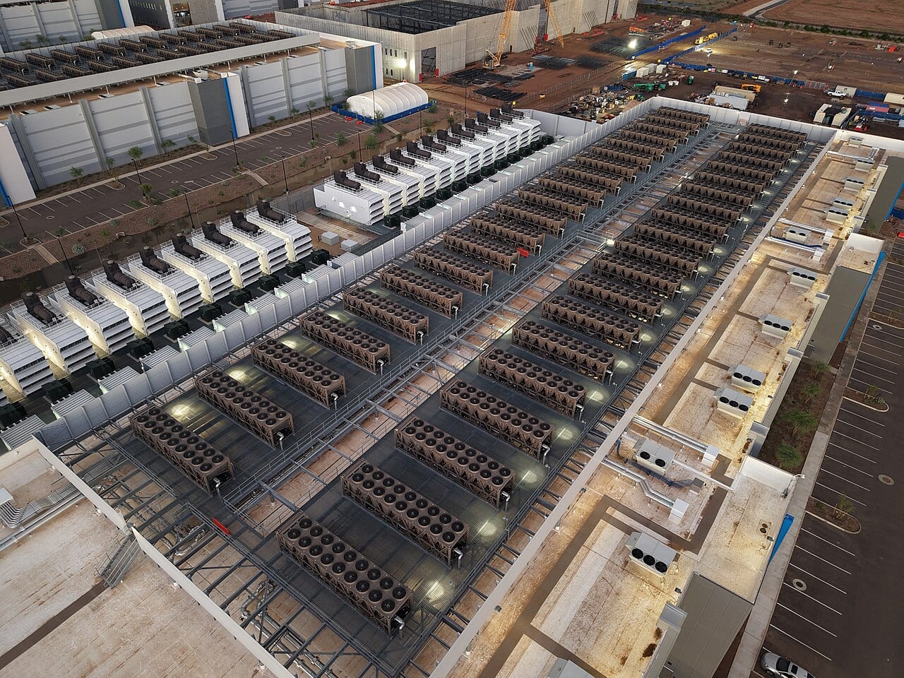 A flat data center roof lined with cooling towers and backup generators