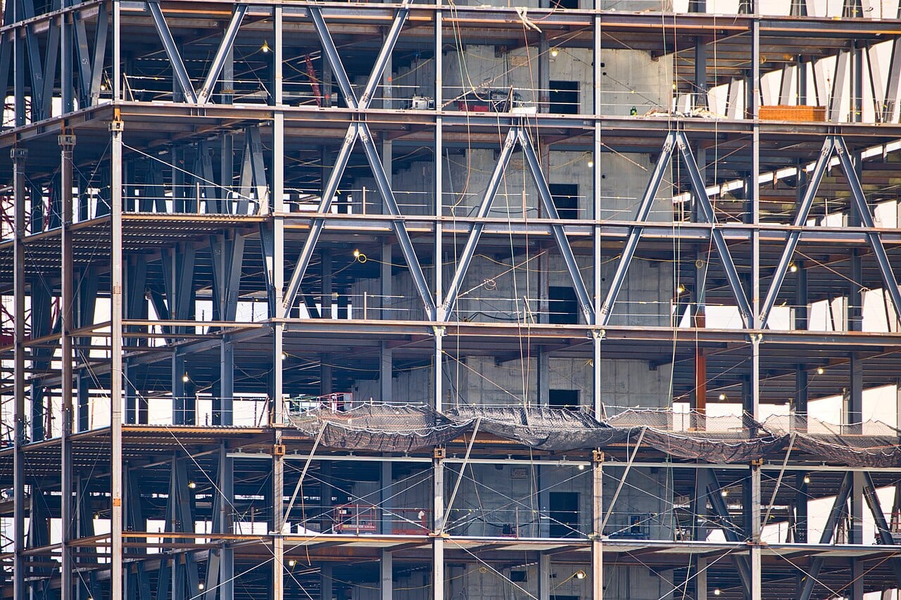 A data center under construction, steel framing exposed and cranes still on site