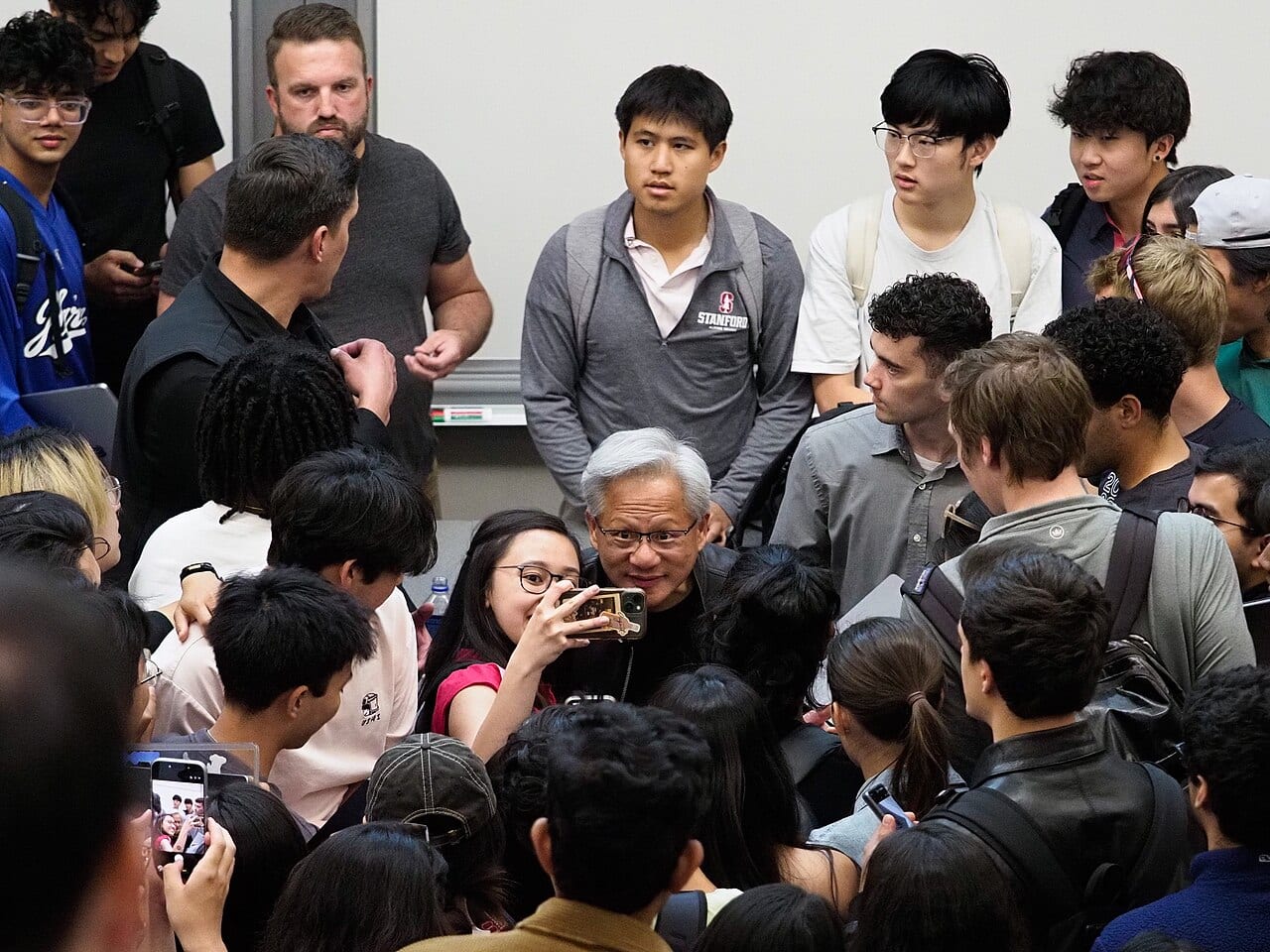 Jensen Huang, Nvidia's founder and chief executive, poses with students at Stanford University on April 30, 2026