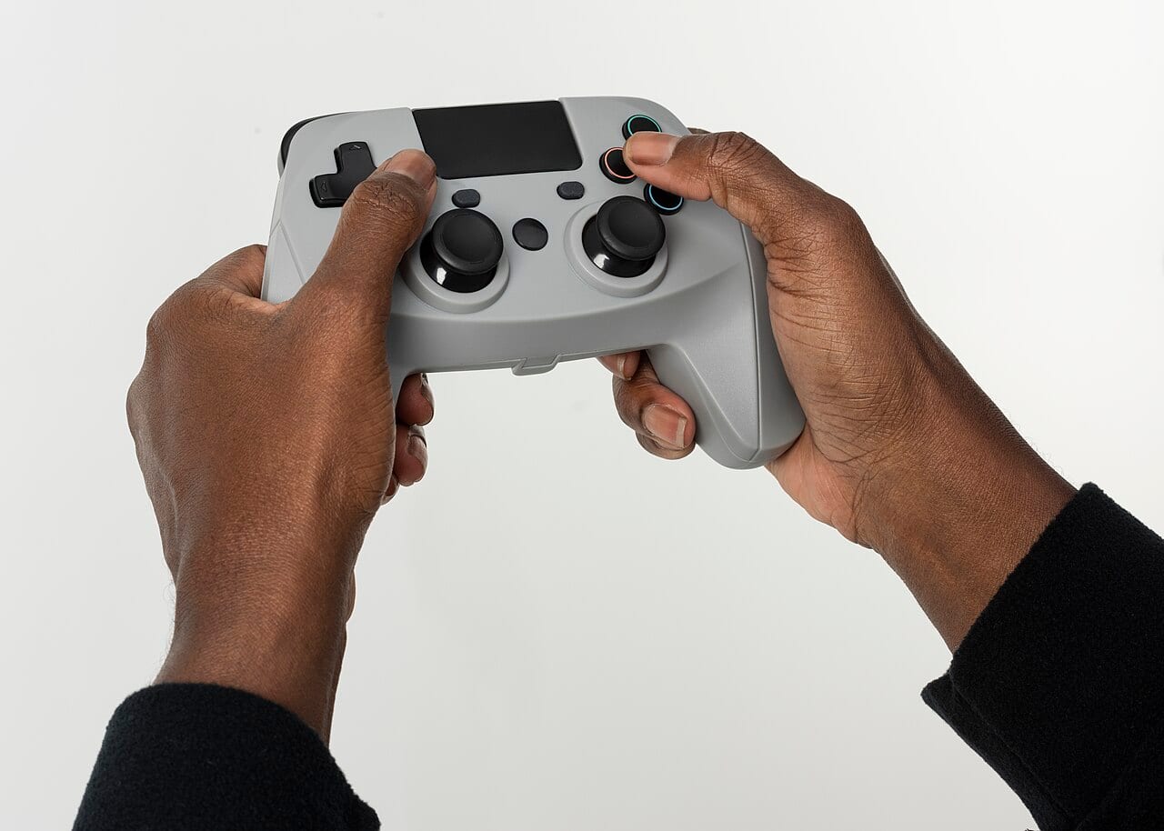 A pair of hands holding a video game controller